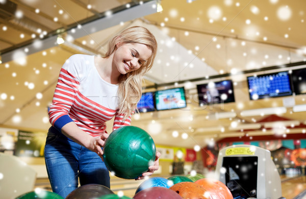 happy young woman holding ball in bowling club Stock photo © dolgachov