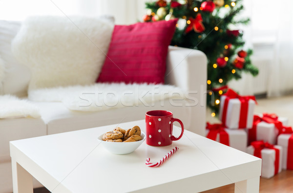 close up of christmas cookies, sugar cane and cup Stock photo © dolgachov