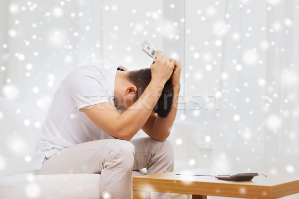 man with money and calculator at home Stock photo © dolgachov