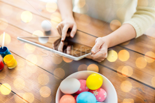 close up of woman with tablet pc and easter eggs Stock photo © dolgachov