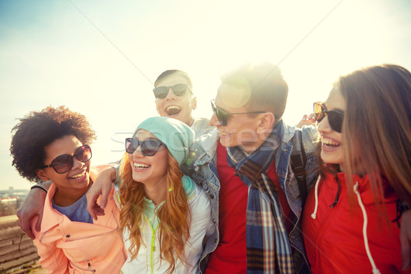 smiling friends in sunglasses laughing on street Stock photo © dolgachov