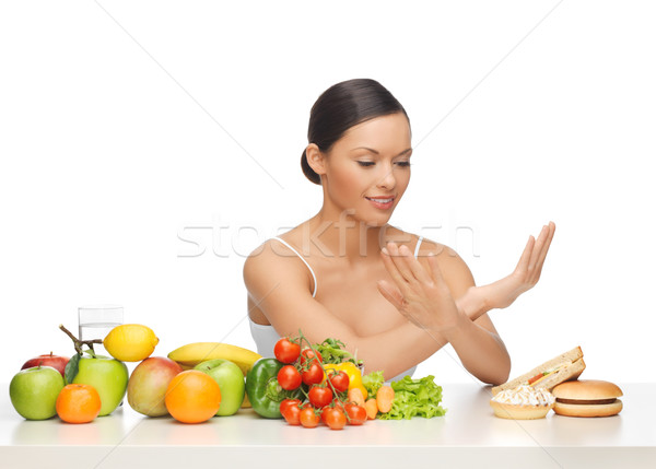 woman with fruits rejecting hamburger Stock photo © dolgachov