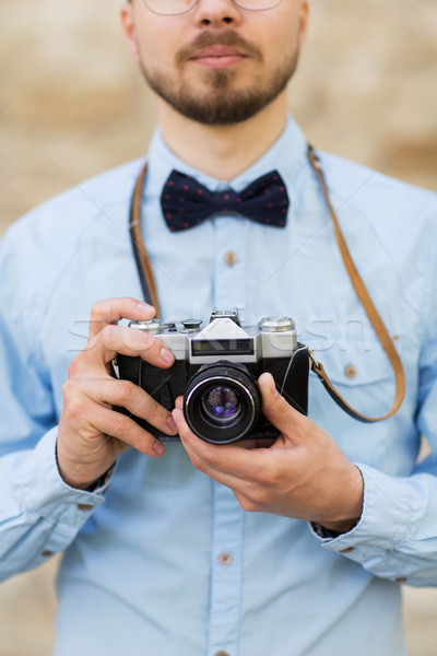 close up of hipster man with film camera in city Stock photo © dolgachov