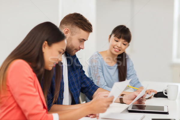 happy creative team or students working at office Stock photo © dolgachov