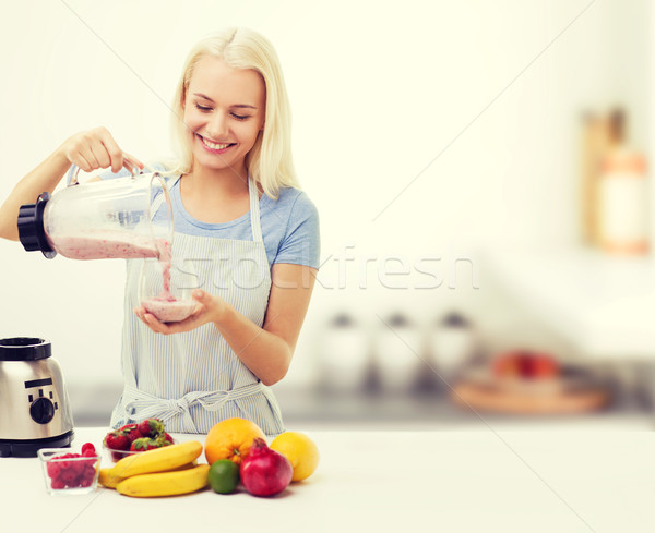 smiling woman with blender and fruit milk shake Stock photo © dolgachov