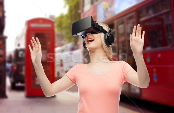 woman in virtual reality headset or 3d glasses Stock photo © dolgachov