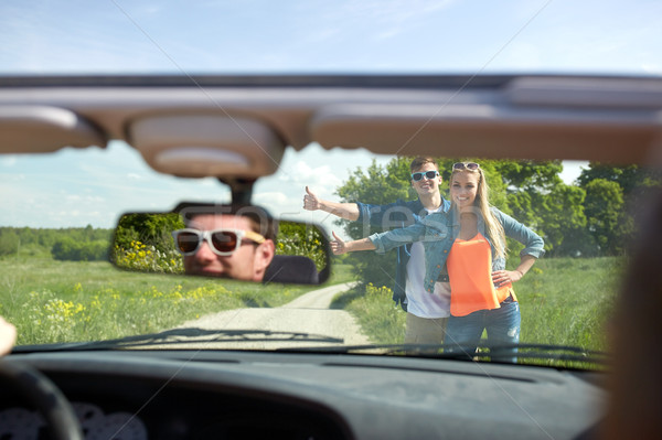 couple hitchhiking and stopping car on countryside Stock photo © dolgachov