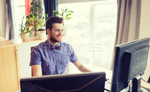 happy creative male office worker with computer Stock photo © dolgachov