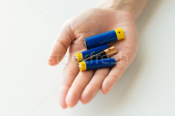 close up of hands holding alkaline batteries heap Stock photo © dolgachov