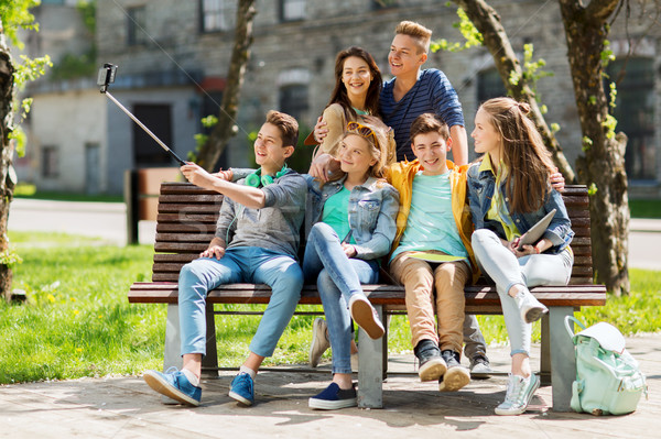 Stock photo: happy teenage students taking selfie by smartphone