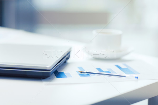 Stock photo: close up of laptop computer, charts and coffee