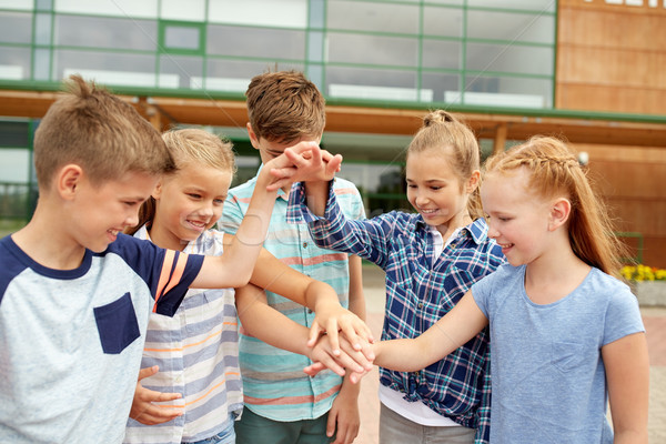 group of happy elementary school students Stock photo © dolgachov