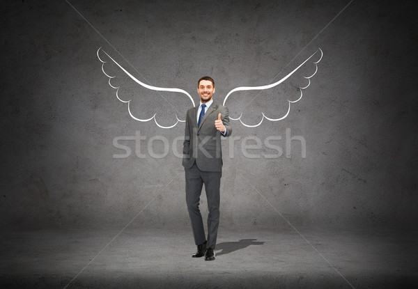 businessman with angel wings showing thumbs up Stock photo © dolgachov