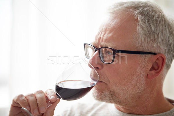 close up of senior man drinking wine from glass Stock photo © dolgachov