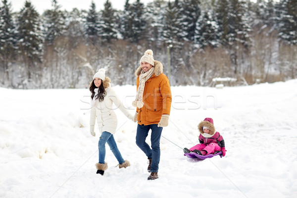 happy family with sled walking in winter forest Stock photo © dolgachov