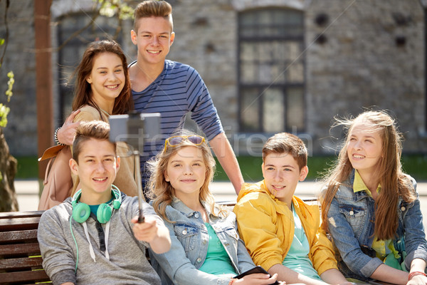 Stock photo: happy teenage students taking selfie by smartphone
