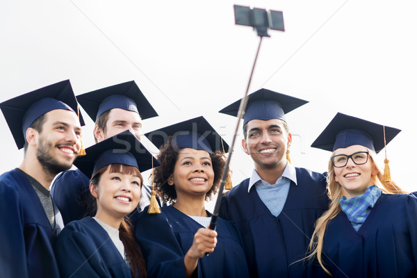 students or bachelors taking selfie by smartphone Stock photo © dolgachov