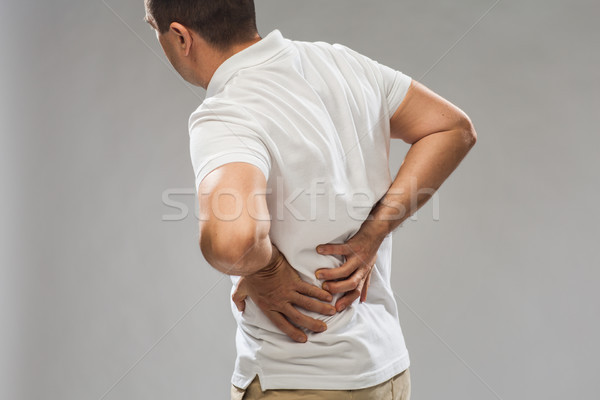 Człowiek cierpienie ból w krzyżu ludzi opieki zdrowotnej Zdjęcia stock © dolgachov