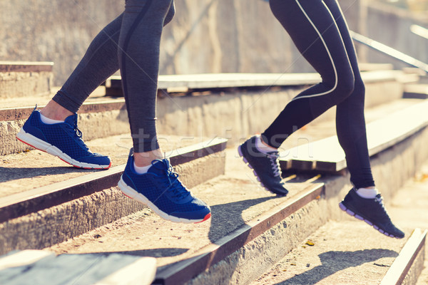 close up of couple running downstairs on stadium Stock photo © dolgachov