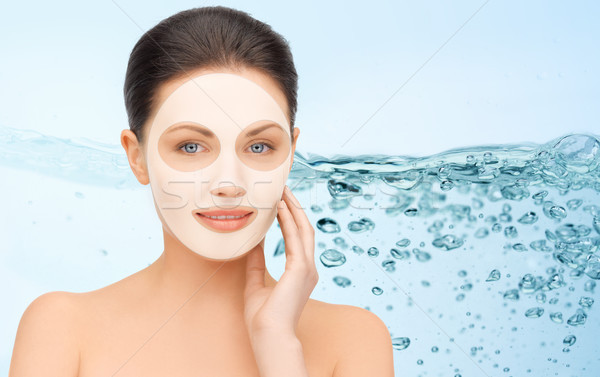 beautiful young woman with collagen facial mask Stock photo © dolgachov