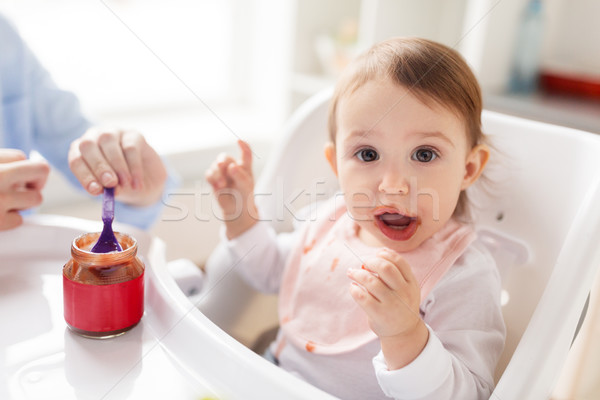 mother feeding baby with puree at home Stock photo © dolgachov