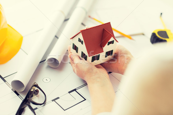 close up of hands with house model above blueprint Stock photo © dolgachov