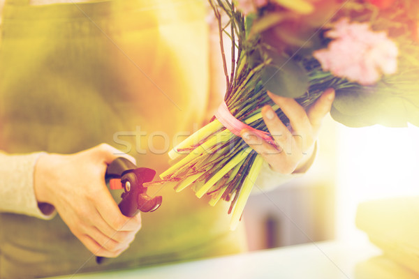 close up of florist woman with flowers and pruner Stock photo © dolgachov
