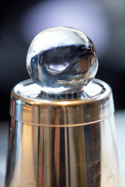 hand-cut ice ball on top of cocktail shaker at bar Stock photo © dolgachov
