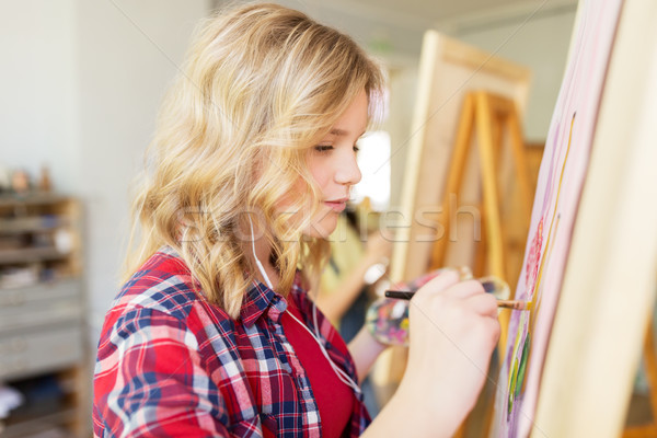 student girl with easel painting at art school Stock photo © dolgachov