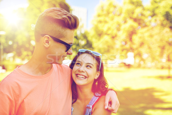 happy teenage couple looking at each other in park Stock photo © dolgachov