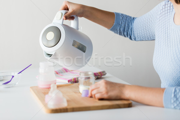 Kezek bogrács üveg készít baba tej Stock fotó © dolgachov