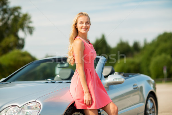 happy young woman posing at convertible car Stock photo © dolgachov