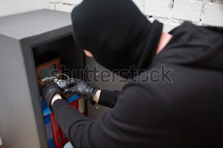 thief stealing valuables from safe at crime scene Stock photo © dolgachov