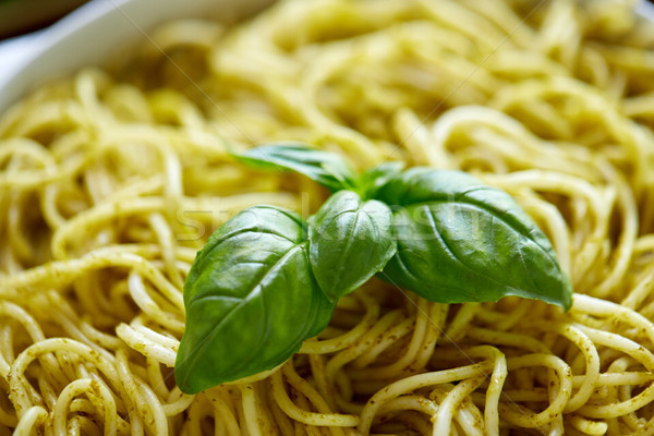close up of cooked pasta with basil leaves Stock photo © dolgachov