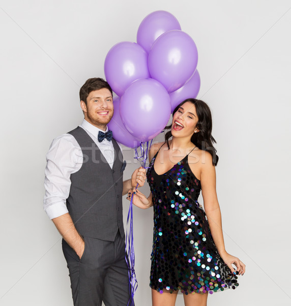 happy couple with ultra violet balloons at party Stock photo © dolgachov