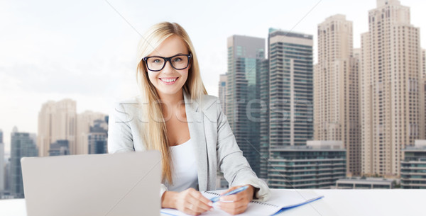 businesswoman with notepad and laptop at office Stock photo © dolgachov