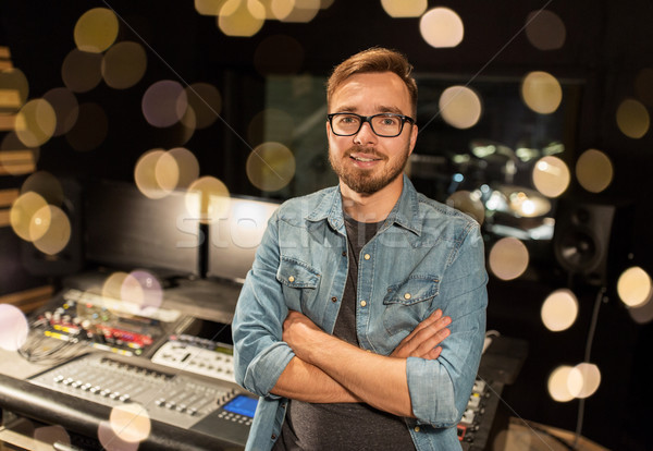 Stock photo: man at mixing console in music recording studio