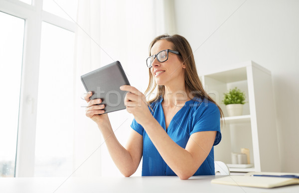 woman with tablet pc working at home or office Stock photo © dolgachov
