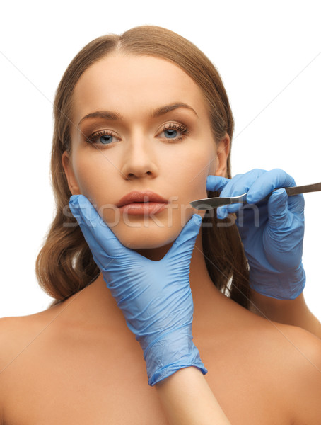 woman face and beautician hands Stock photo © dolgachov