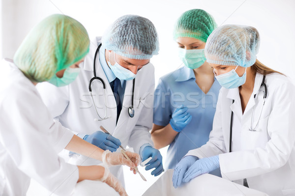 young group of doctors doing operation Stock photo © dolgachov