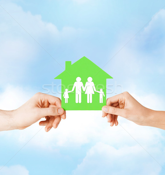 hands holding green house with family Stock photo © dolgachov