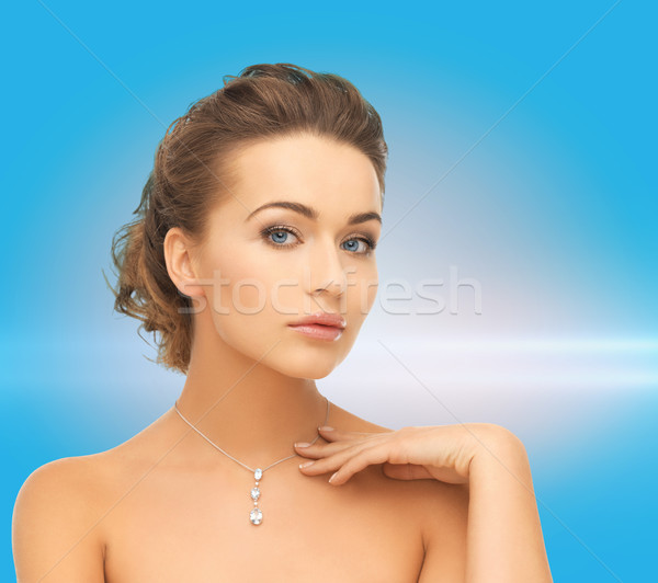 woman wearing shiny diamond pendant Stock photo © dolgachov