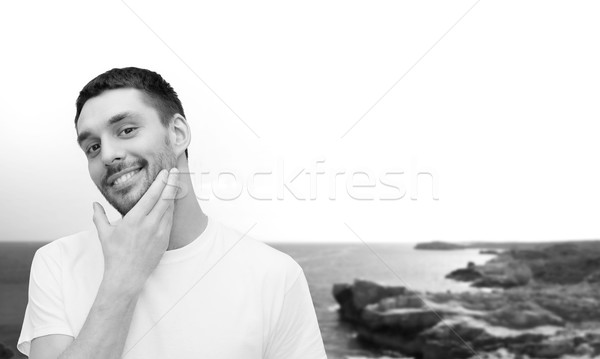 Schönen lächelnd Mann anfassen Gesicht Gesundheit Stock foto © dolgachov