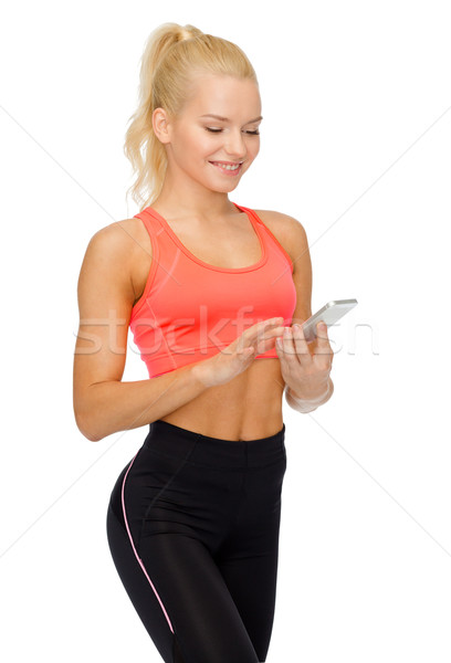 smiling sporty woman with smartphone Stock photo © dolgachov