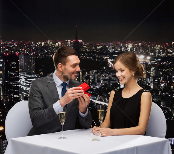 Excité jeune femme regarder copain boîte restaurant [[stock_photo]] © dolgachov