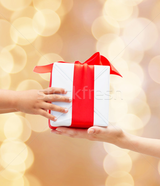 close up of child and mother hands with gift box Stock photo © dolgachov