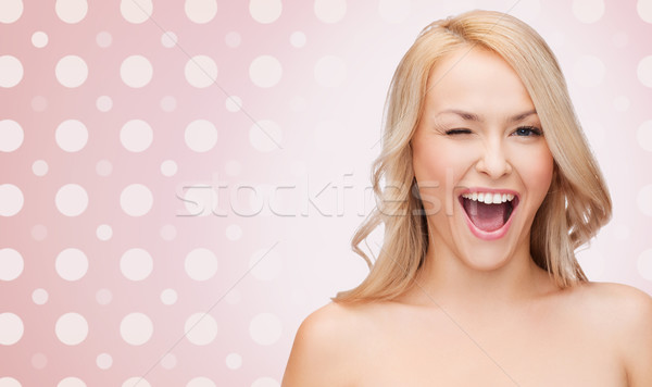 beautiful young woman over polka dot background Stock photo © dolgachov