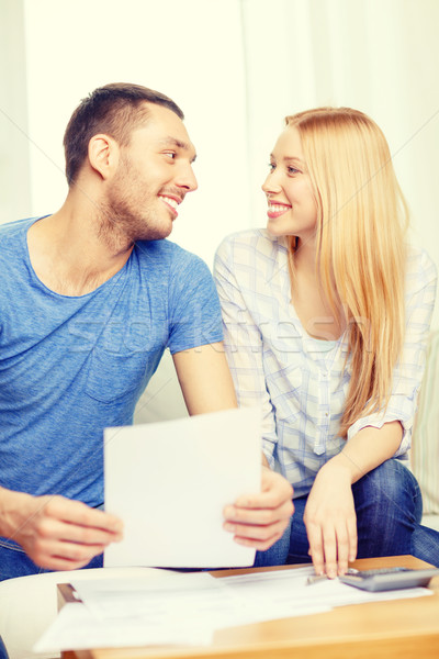 smiling couple with papers and calculator at home Stock photo © dolgachov