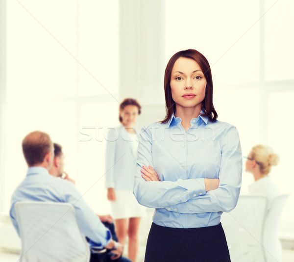 smiling businesswoman with crossed arms at office Stock photo © dolgachov