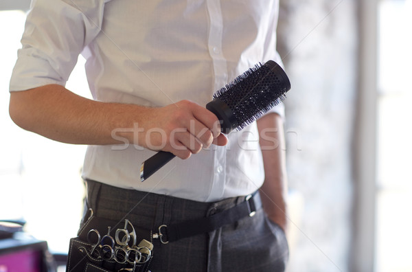 close up of male stylist with brush at salon Stock photo © dolgachov